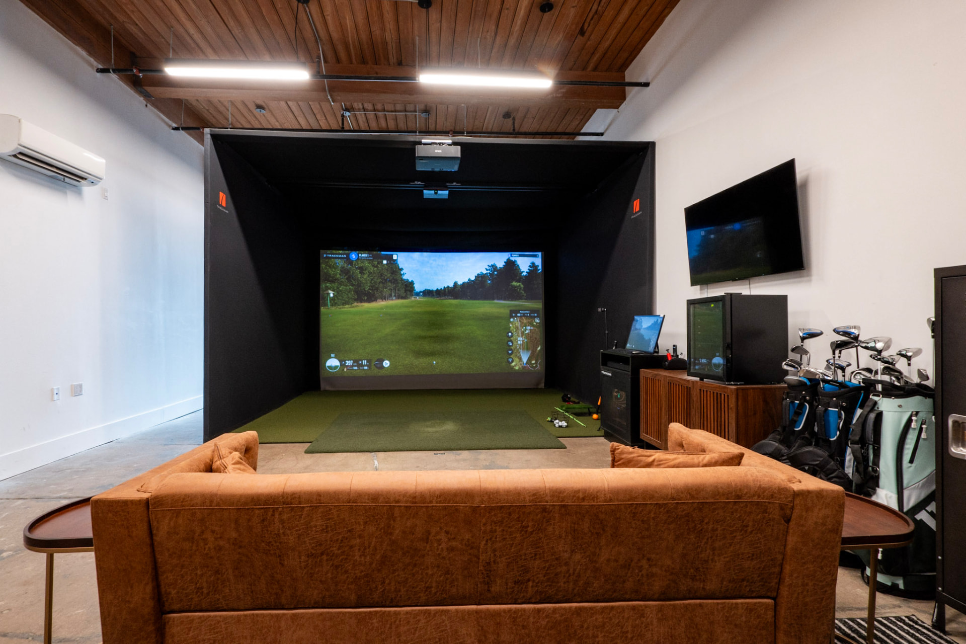 Trackman iO simulator bay with lounge seating and club rentals